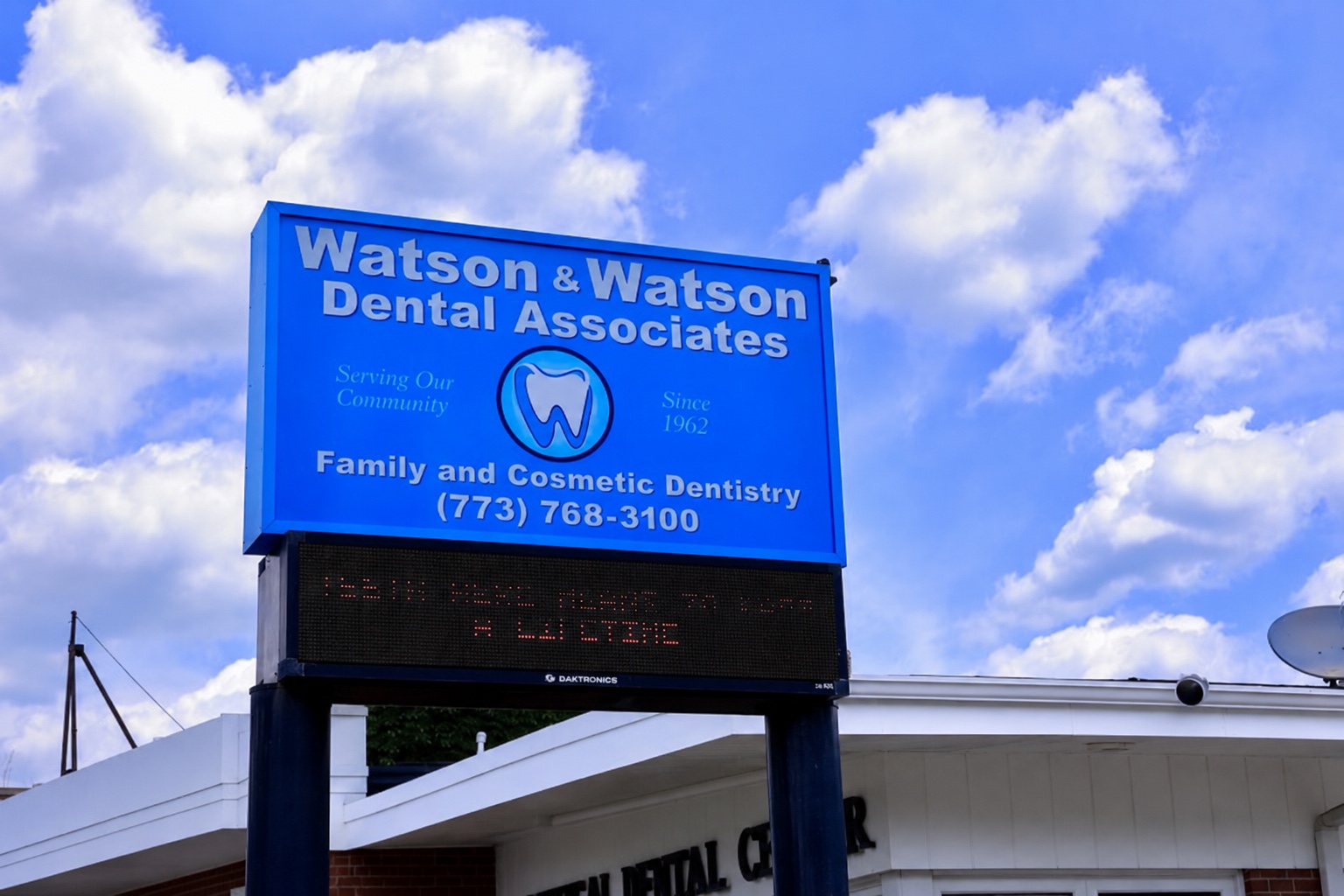 Watson and Watson Dental Associates blue sign against the sky